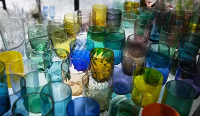 Custom glassware display showing different colors, shapes, and surface finishes