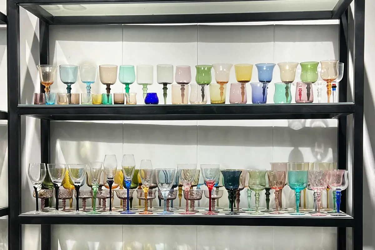 Custom glassware sample display from OEM glassware manufacturer with assorted colored cup and goblet styles