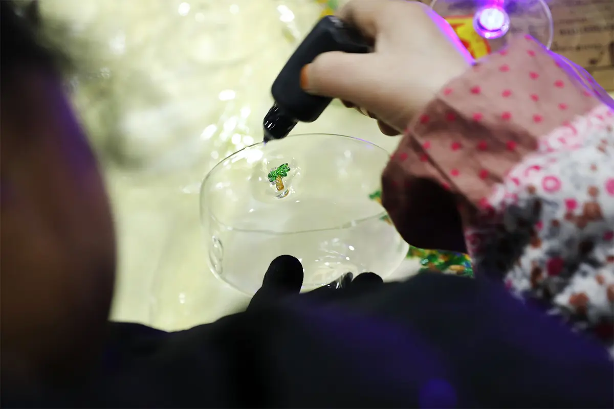 Applying decal decoration to glass cups during the finishing process