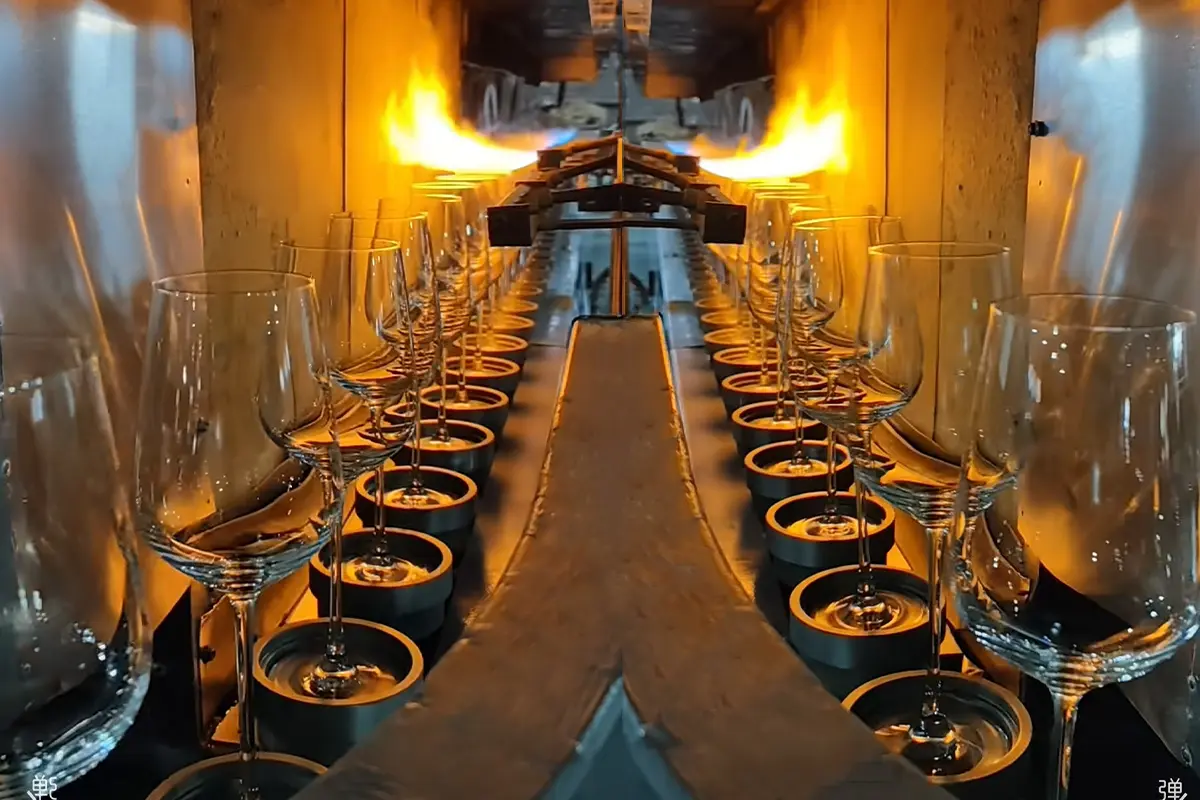Glass cups on a hot forming line during the molding process