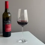 Bordeaux red wine glass with wine bottle in a table setting